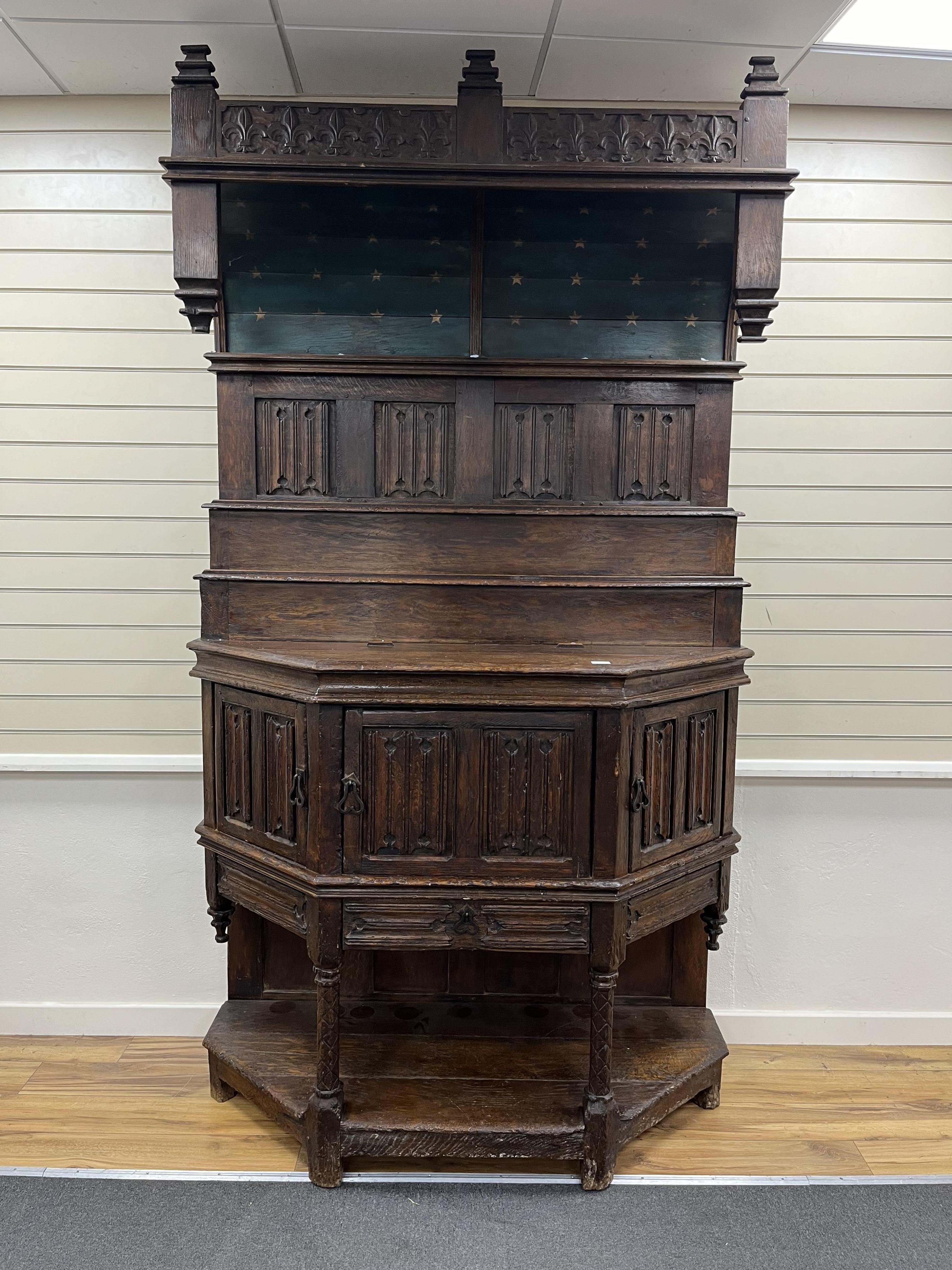 A tall Gothic linenfold panelled oak dresser (dressoir), in 15th century French style, width 143cm, depth 62cm, height 252cm. Condition - fair to good, Provenance - made for Brede Place, Brede, Rye, East Sussex. Commissi